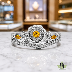 Jewelry Photography Specifications. Visual Style & Composition. Produce ultra-realistic macro photography of the uploaded Product, capturing every detail with precision. Set the Product on a table White Marble surface to achieve a refined and timeless luxury aesthetic. Utilize background bokeh mode to simulate professional jewelry showroom scenes. Maintain absolute fidelity to the reference file regarding product design, diamond details, and camera angles. Technical Requirements & Branding. Output image quality must be exactly 2100 x 2100 pixels. Metal Color Change to White Gold.